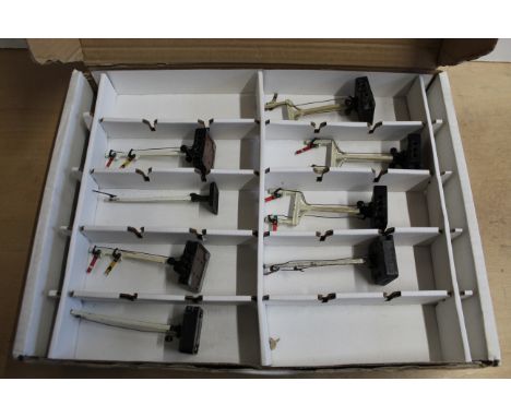A box with two layers containing various Hornby signals, carriages, tenders etc