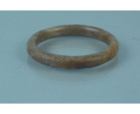 A jade bangle with engraved detail