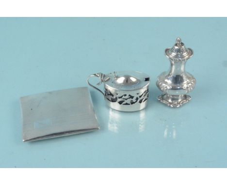 A silver pepperette, a silver mustard of pierced design with blue glass liner plus a silver cigarette case with engine turned