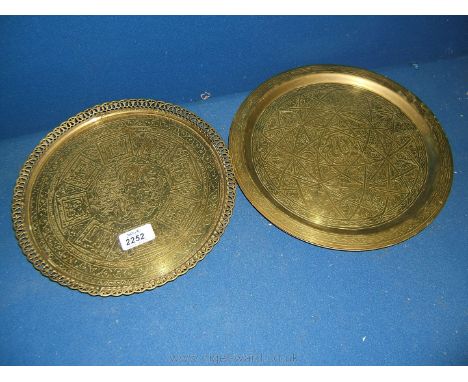 A circular Brass hunting Tray with central deer design and script with ornate pierced edge together with a pair of geometric 
