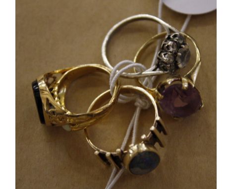  A 9ct gold ring with purple coloured stone  , a gold and opal ring marked 14K, a gold and opal three stone ring (marks worn)