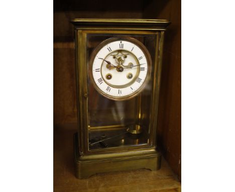  A French 19th Century glass and brass mantel clock,   Roman numeral enamel dial, 28cm x 16cm  