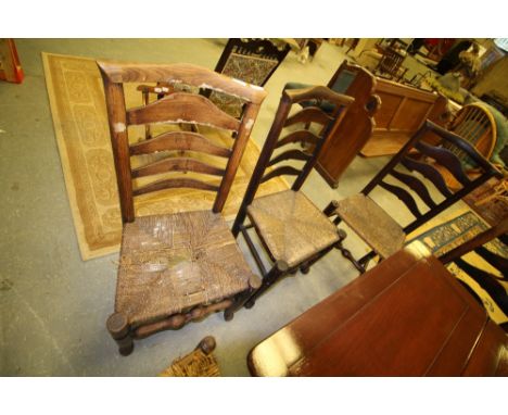 Twelve rush seated ladder back chairs
