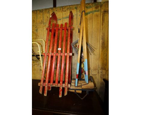 French croquet set and red painted sledge