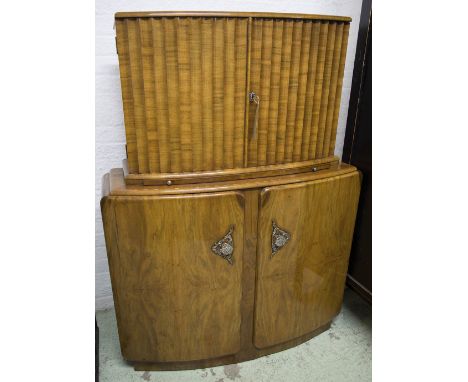 COCKTAIL CABINET, 1930 Art Deco walnut and silvered mounted, two fluted doors above slide all mirror trimmed above two confor