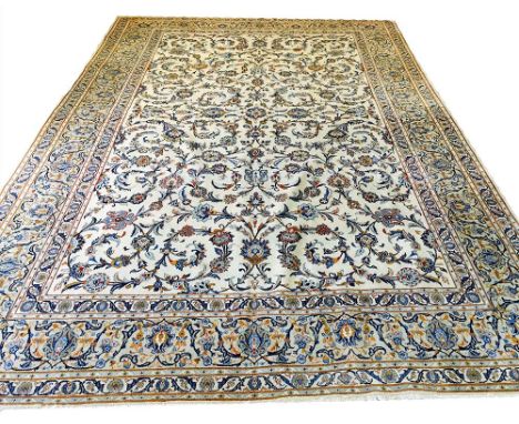 VERY FINE SIGNED KASHAN CARPET, 414cm x 286cm, all over palmette and vine design on an ivory field within complimentary borde