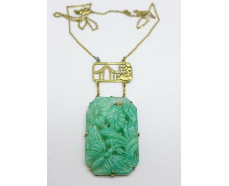 A Chinese carved jade necklet on a plated chain, 39mm x 26mm 