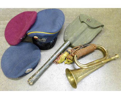 Military items; two berets, peaked cap, bugle and a trench spade 