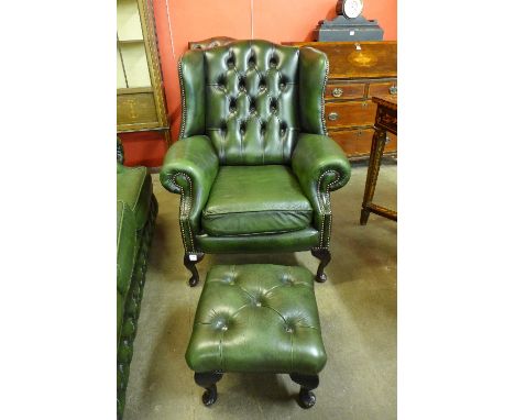 A mahogany and green leather wingback armchair and stool