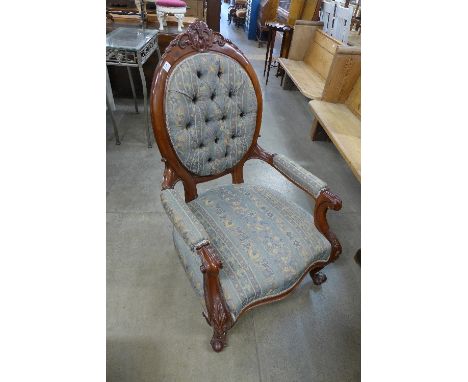 A Victorian style mahogany and upholstered spoonback armchair
