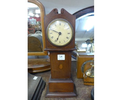 An early 20th Century inlaid mahogany timepiece in the form of a longcase clock