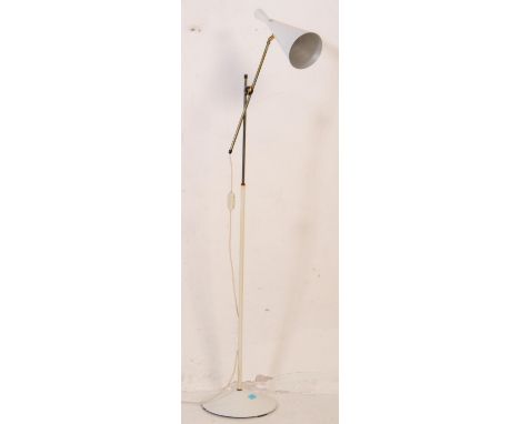 A mid century modern 1950's floor standing lamp light. Having a white enamel conical shade with dual brass tubular supports r