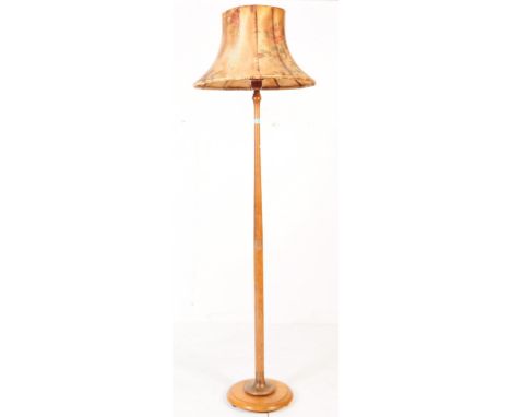 An early 20th century oak floor standing standard lamp. With light fixings to top, with central turned column on a circular b