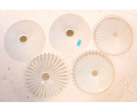 A collection of five 20th century ceramic and milk glass light shades. The lot to include two white ceramic dish shaped shade