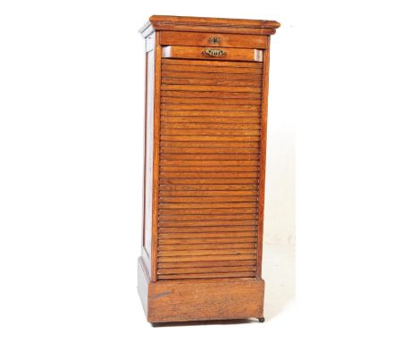 Early 20th century tambour fronted oak stationary office filing cabinet. With half convex, two step&nbsp;top over the tambour