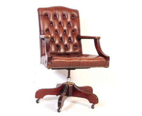 A 20th century Ring Mekanikk Norway captains swivel desk chair. The chair having brown leather button back chesterfield manne