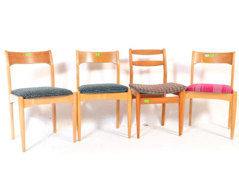 A harlequin set of four mid 20th century teak dining kitchen chairs. Three of the chairs having a single slat curved backrest