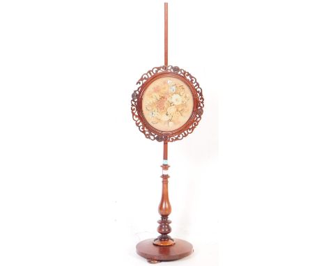 A 19th century High Victorian rosewood pole screen. The terraced circular base with central pole having tapestry needlepoint 