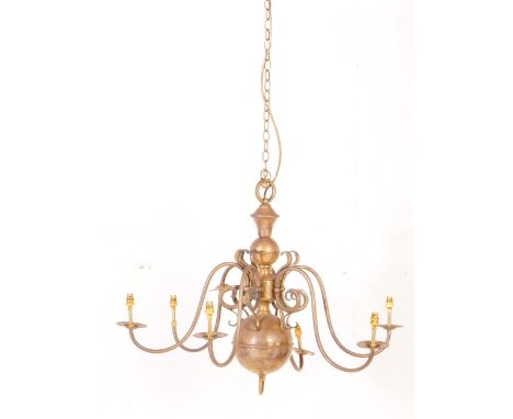 A 20th century Dutch style brass six branch chandelier / light fitting. Having six scrolling branches extending from a fluted
