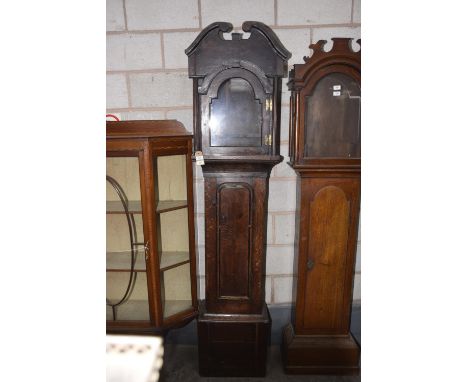 A primitive oak longcase clock case, early 17th CenturyHaving a twin swan neck pediment above a break arched glazed door flan