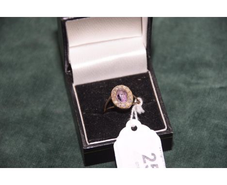 An amethyst and pearl cluster ring in yellow metalWeight approx 2.7g. 