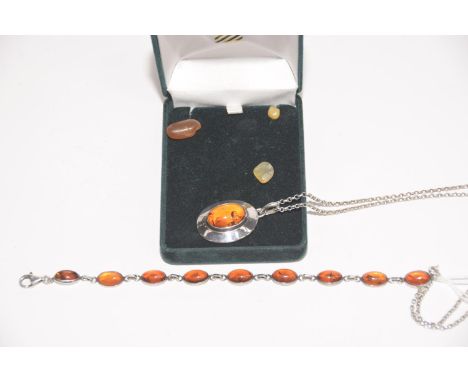 A silver amber pendant on chain together with a silver amber bracelet, total weight approx. 22.9g. 