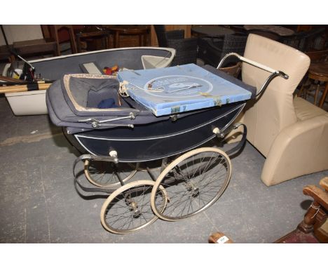 A vintage Marniet pramMounted upon leaf springs and solid rubber tyres. 