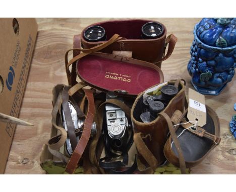 A leather cased pair of Carl Zeiss binocularsA pair of Dollond cased binoculars, a Comets camera and one other. 