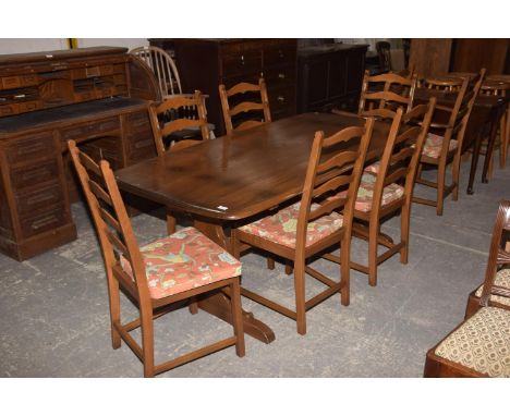 A Mid 20th Century Ercol Medium Elm Refectory Table with 8 Conforming Ladder Back Dining Chairs Inc 2 x Carvers 