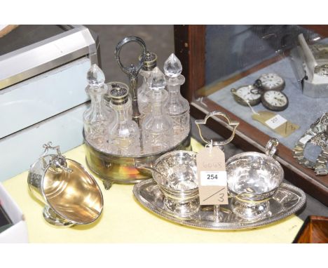 Silver plated six bottle cruetA plated cream jug and sugar basin, and a helmet shaped sugar basin. (3) 