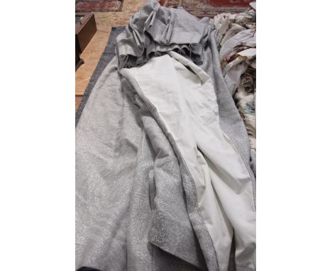A pair of mottled grey lined curtains. 