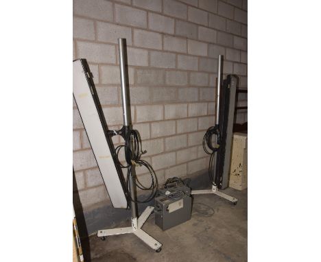 A pair of mid 20th Century Luminary Lighting Company studio lamps complete with pole uprights and a pair of power packs. 