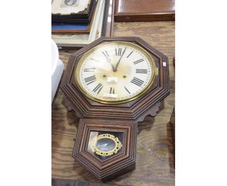 A Late 19th Early 20th Century American Walnut Cased Octaganol Wall Clock with two Train Movement and Enamel Dial 