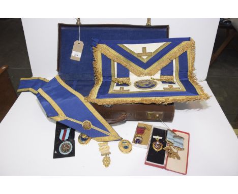 A collection of Masonic related itemsTo include a sash, aprons, various medals and pendants. 