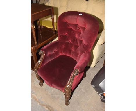 A Victorian rosewood and upholstered button back armchair. 