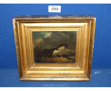 A gilt framed, very well executed diminutive Oil painting on panel superbly portraying two highly distressed horses standing 