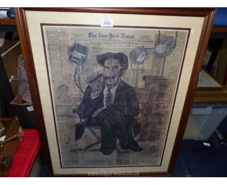A wooden framed Print of the New York Times 1922 with a drawing of Julius Henry "Groucho" Marx sat in a directors chair with 