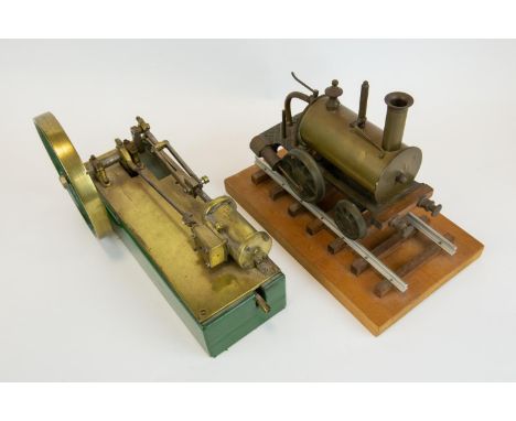 A horizontal single cylinder steam engine. Of mostly brass construction, fitted with a 13.5cm flywheel, single cam driven val