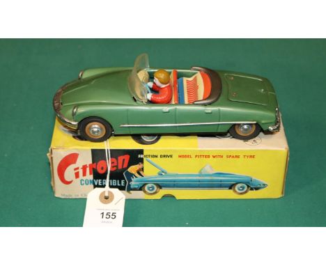 A scarce early 1960's SFTF tinplate 1:24 scale friction powered model of a Citroen ID19 DS 4-door Convertible. In green with 