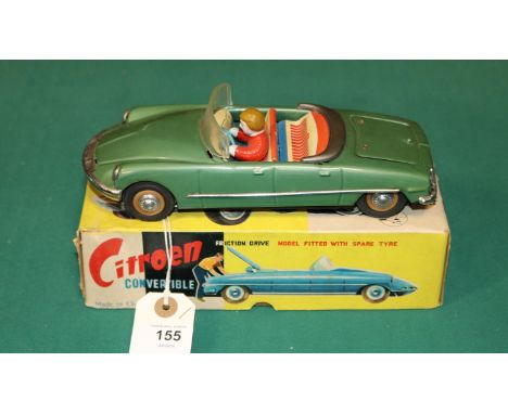 A scarce early 1960's SFTF tinplate 1:24 scale friction powered model of a Citroen ID19 DS 4-door Convertible. In green with 