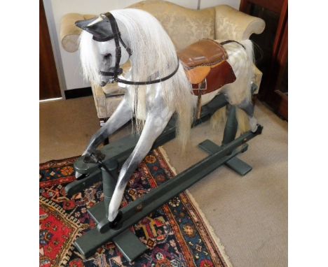 AN EARLY 20TH CENTURY 'SAFETY' ROCKING HORSE , this solid lime rocking horse has been expertly restored and he is sporting a 