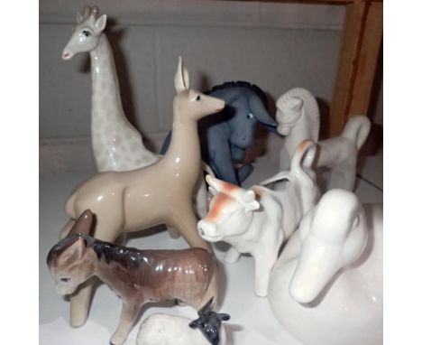 Eight ceramic animal figures including a stylised giraffe and a Beswick black faced ewe. Not available for in-house P&amp;P 