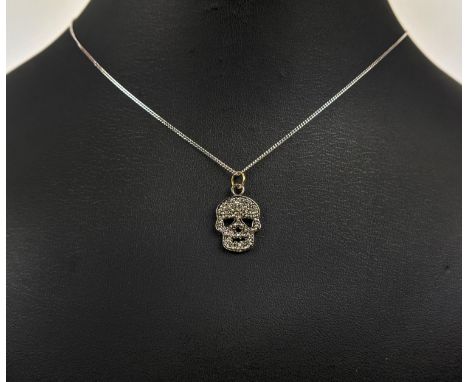 A SILVER AND DIAMOND SET SKULL PENDANT, Italian silver chain, 46cm long, complete with box. 