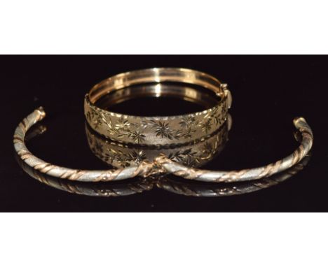 A 9ct gold bangle with cut out floral decoration and a 9ct bi-coloured bangle, 18.6g&nbsp;
