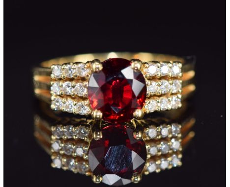 An 18ct gold ring set with a oval cut ruby of approximately 1.4ct and diamonds, 5g, size N