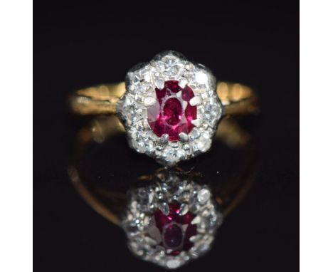 A c1920 18ct gold ring set with a ruby and diamonds, 1.6g, size F