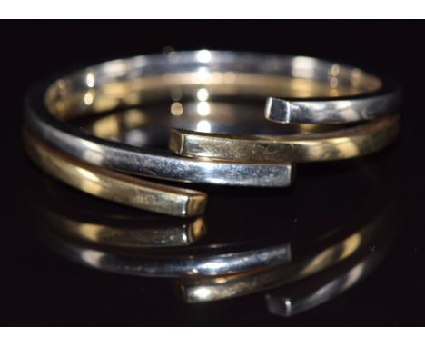 A 9ct gold bi-coloured bangle, 21.4g&nbsp;