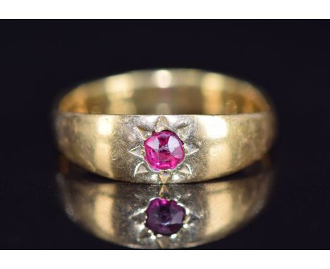 A c1910 18ct gold ring set with a ruby in a star setting, 3.9g, size M