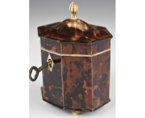 Octagonal tortoiseshell style tea caddy raised on four ball feet, height 12cm