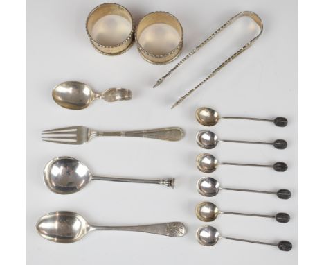 Mainly hallmarked silver cutlery comprising Georgian sugar tongs, set of six coffee bean spoons, fork, seal top spoon, teaspo